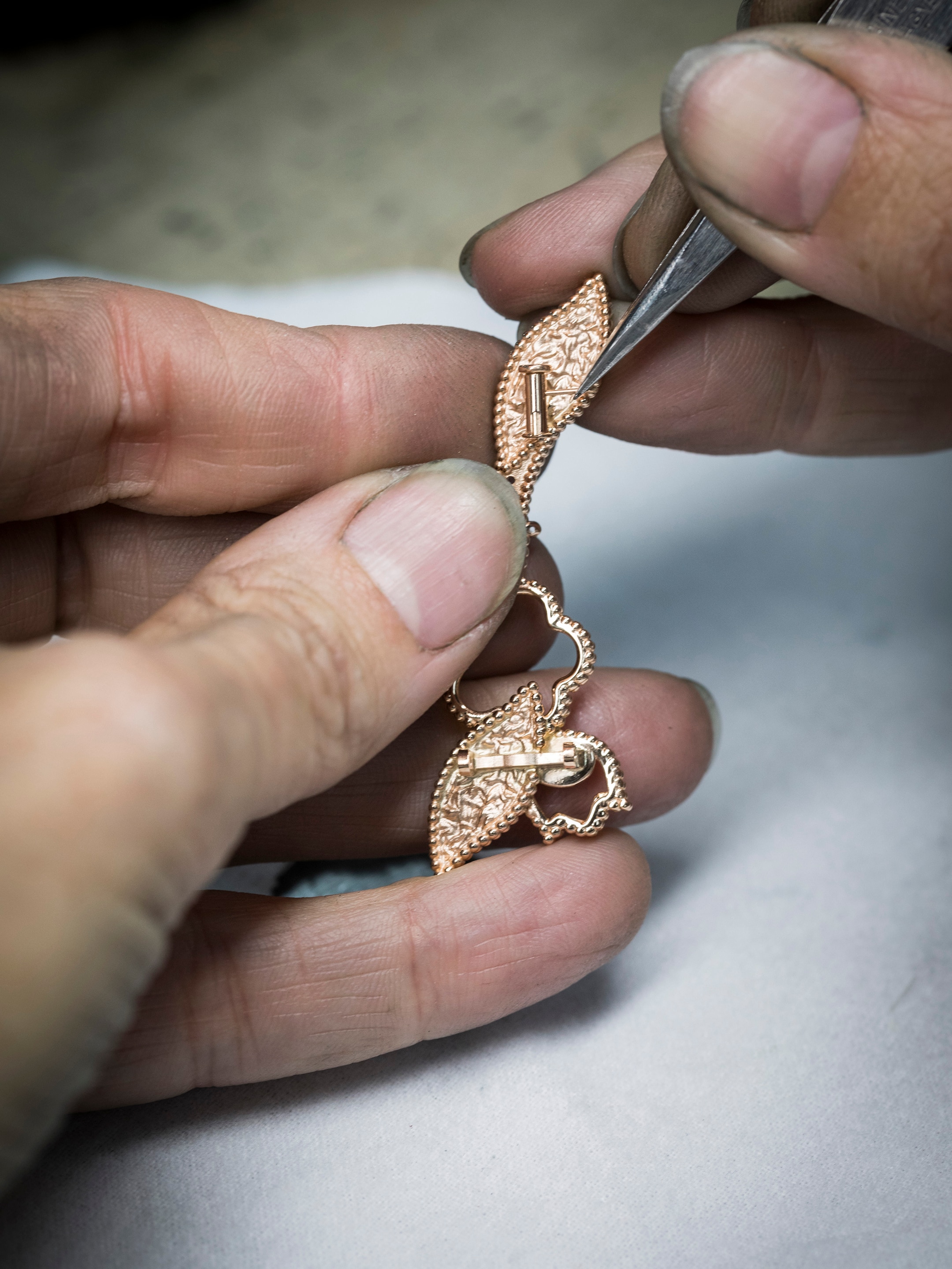 Lucky Spring clip. 18K rose gold, carnelian, mother-of-pearl, onyx. Lucky Spring collection, Van Cleef & Arpels.