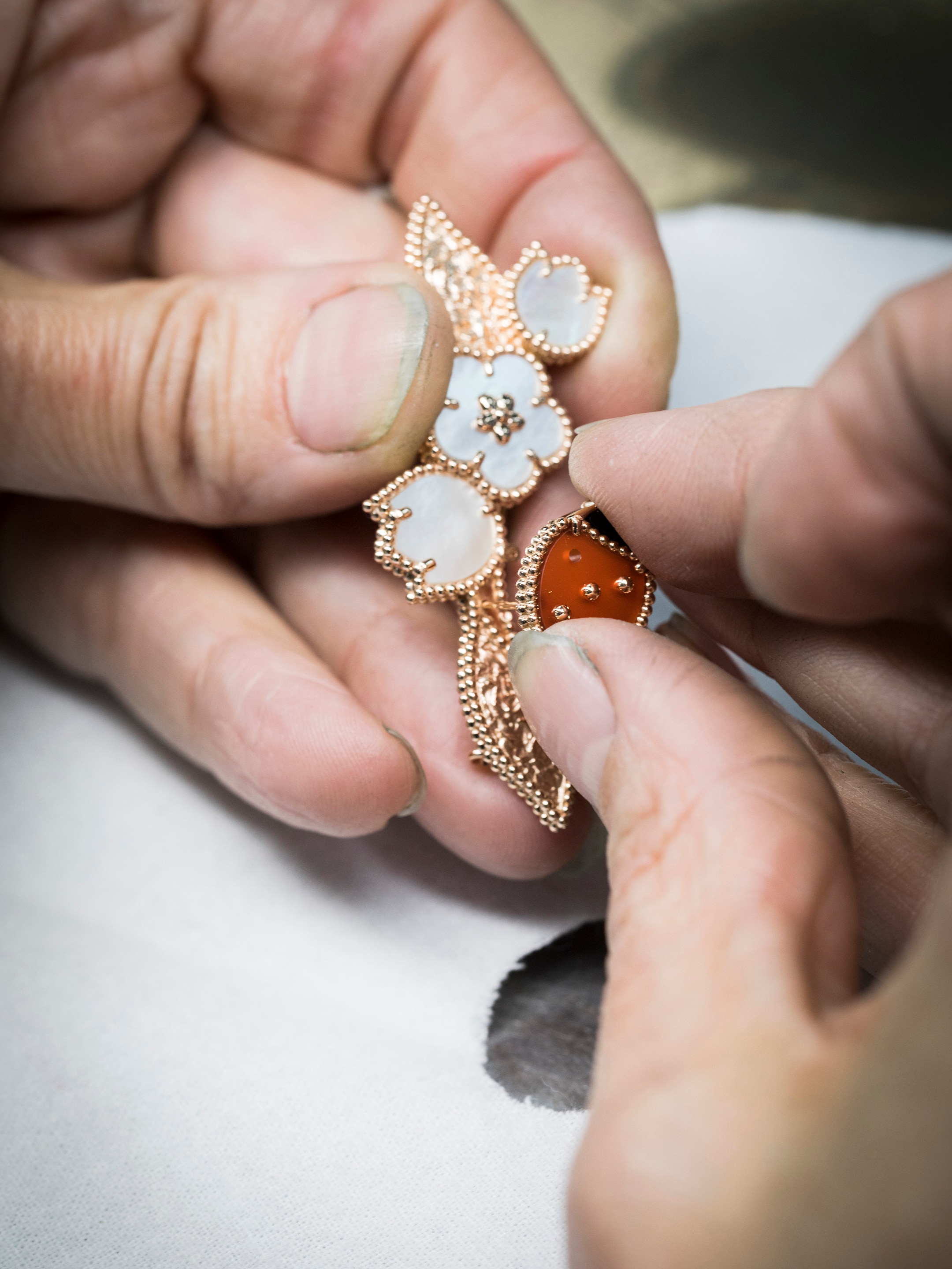 Lucky Spring clip. 18K rose gold, carnelian, mother-of-pearl, onyx. Lucky Spring collection, Van Cleef & Arpels.
