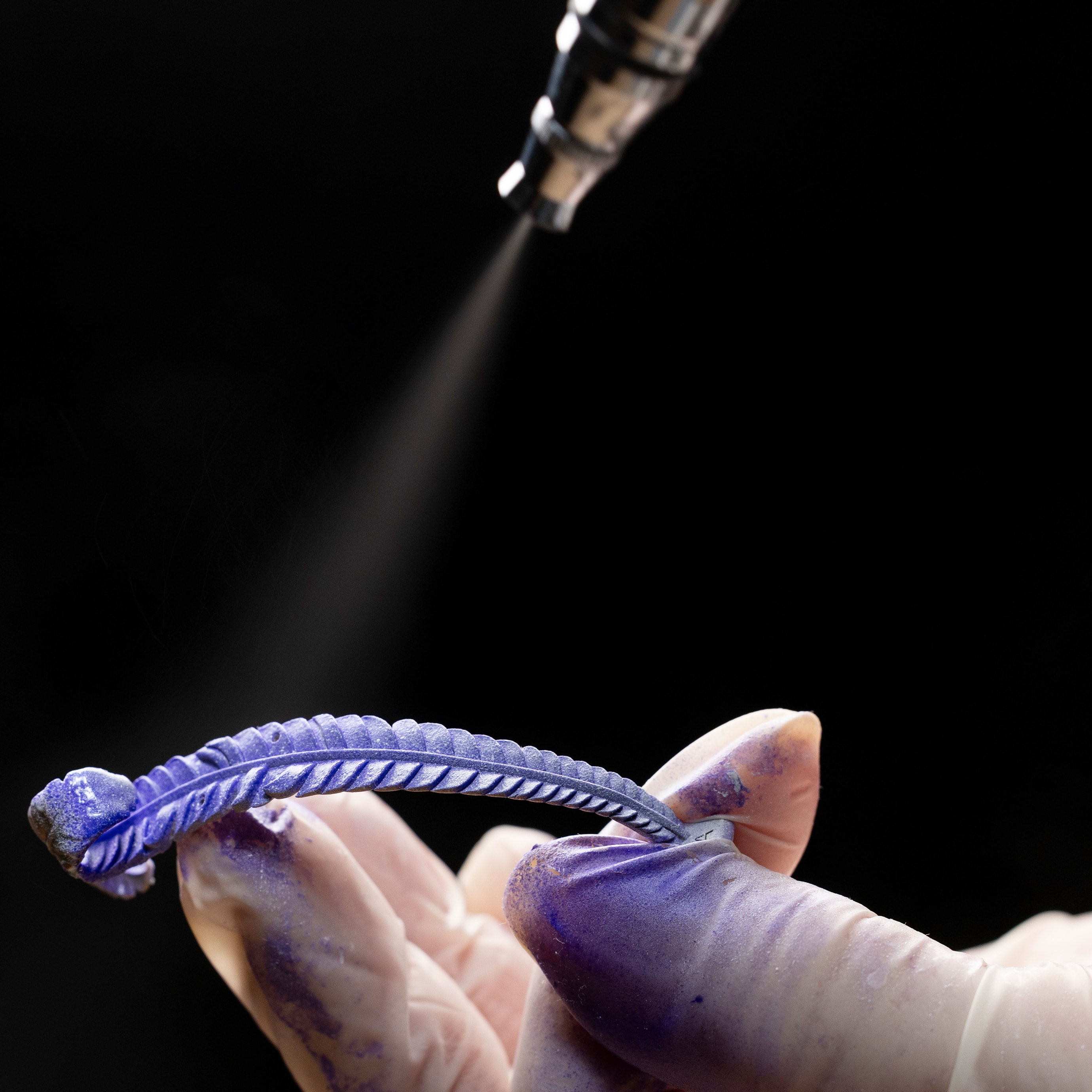Airbrush lacquer application on a rose gold feather, Van Cleef & Arpels.