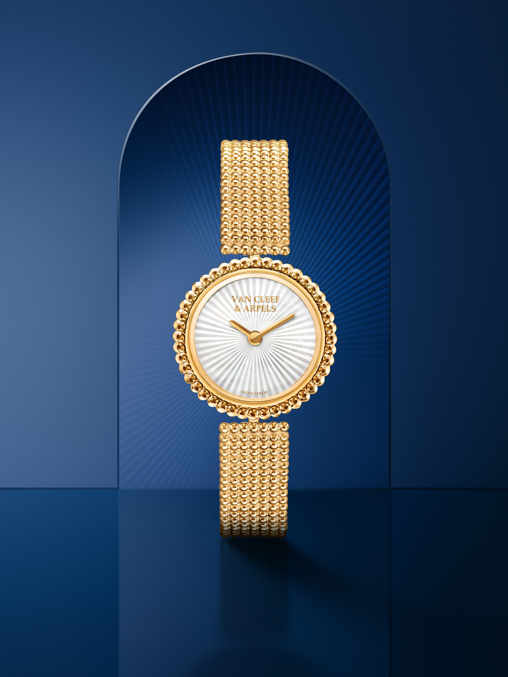 Perlée watch. 18K yellow gold, white mother-of-pearl, Swiss quartz movement. Perlée® collection, Van Cleef & Arpels.