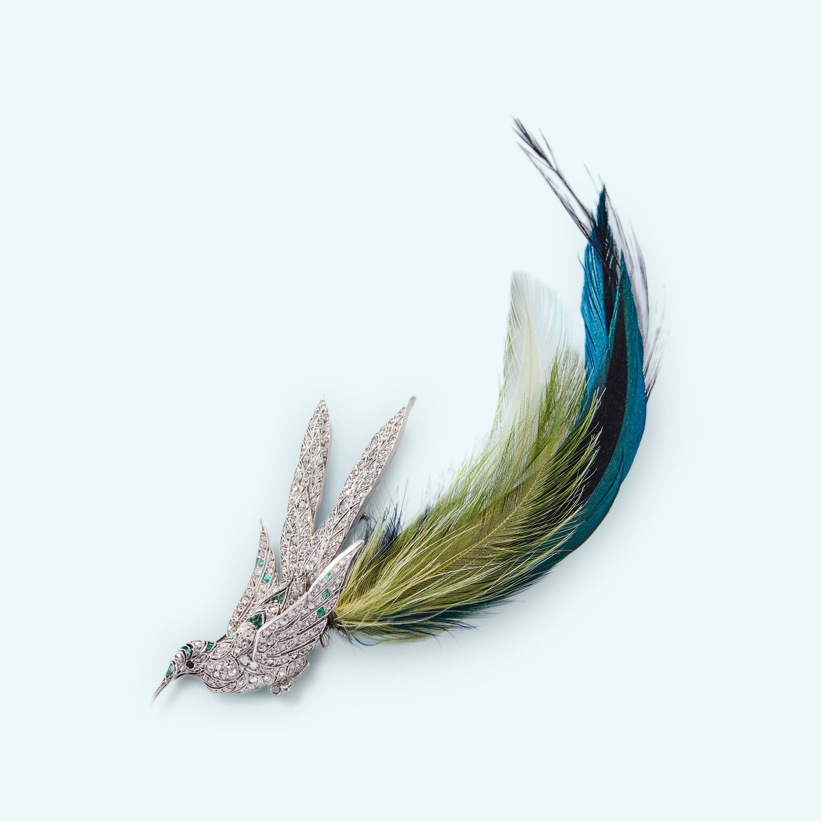 Van Cleef & Arpels, Bird Brooch, 1920's, diamonds, emeralds, onyx, green feathers, platinum. Private collection