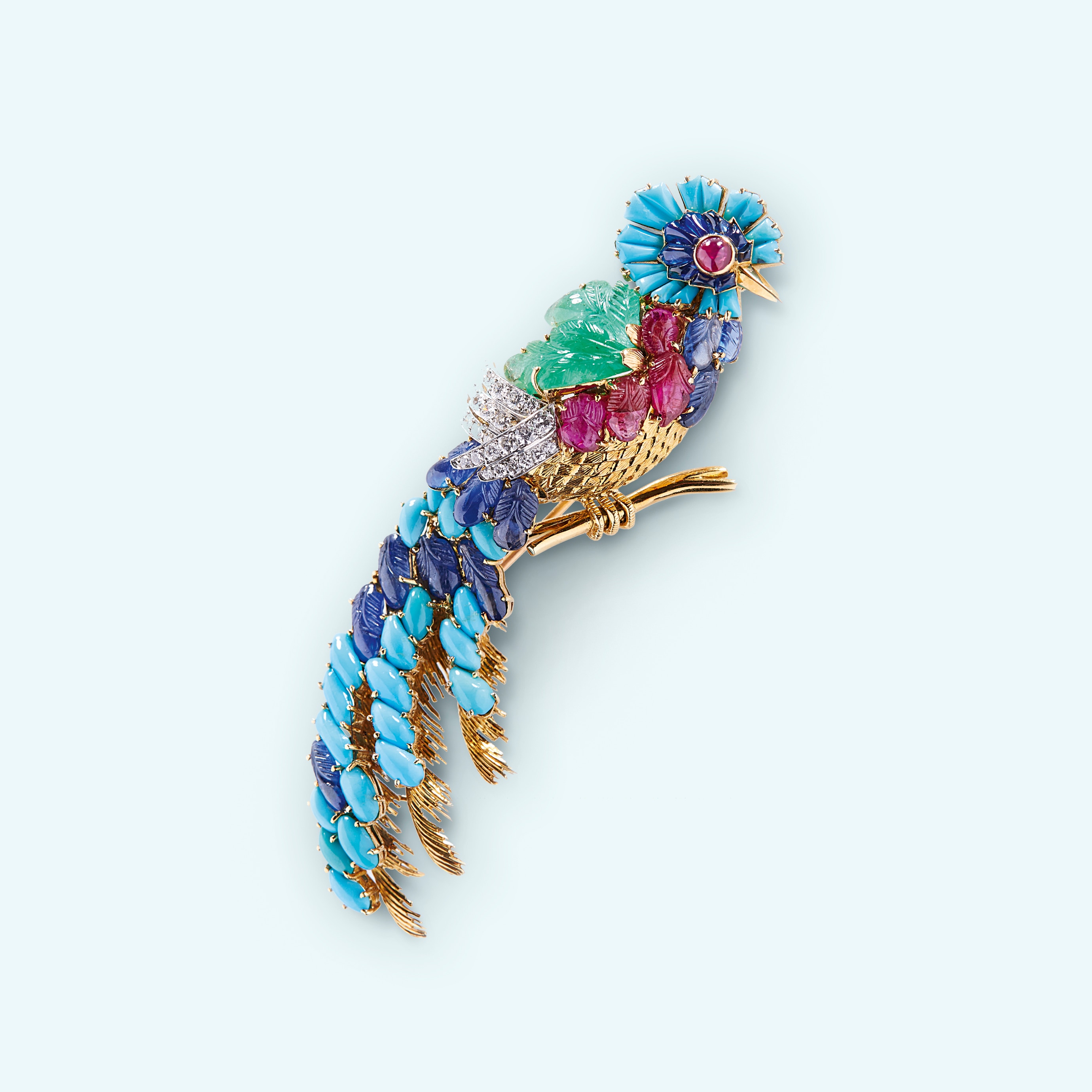 Mauboussin, Quetzal Brooch, 1960's, chased and guilloché yellow gold, sapphires and engraved sapphires, engraved emeralds, turquoises, diamonds, rubies and engraved rubies. Private collection