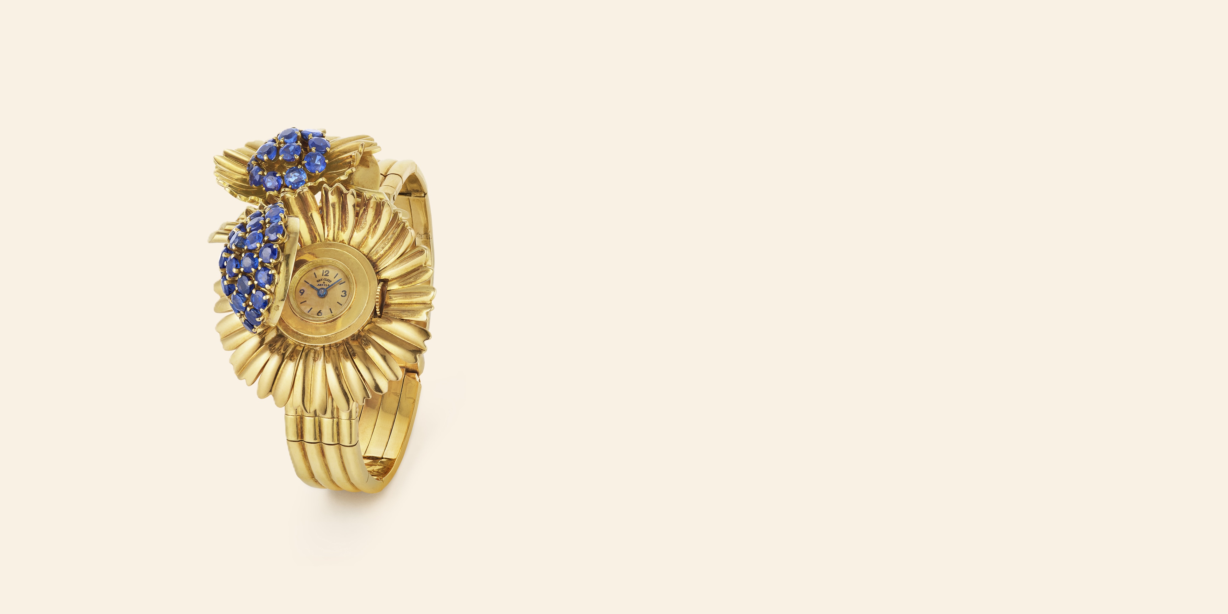 Two-flower wristwatch, 1951. Detachable Two-flower clip Yellow gold, sapphires. Van Cleef & Arpels Collection.
