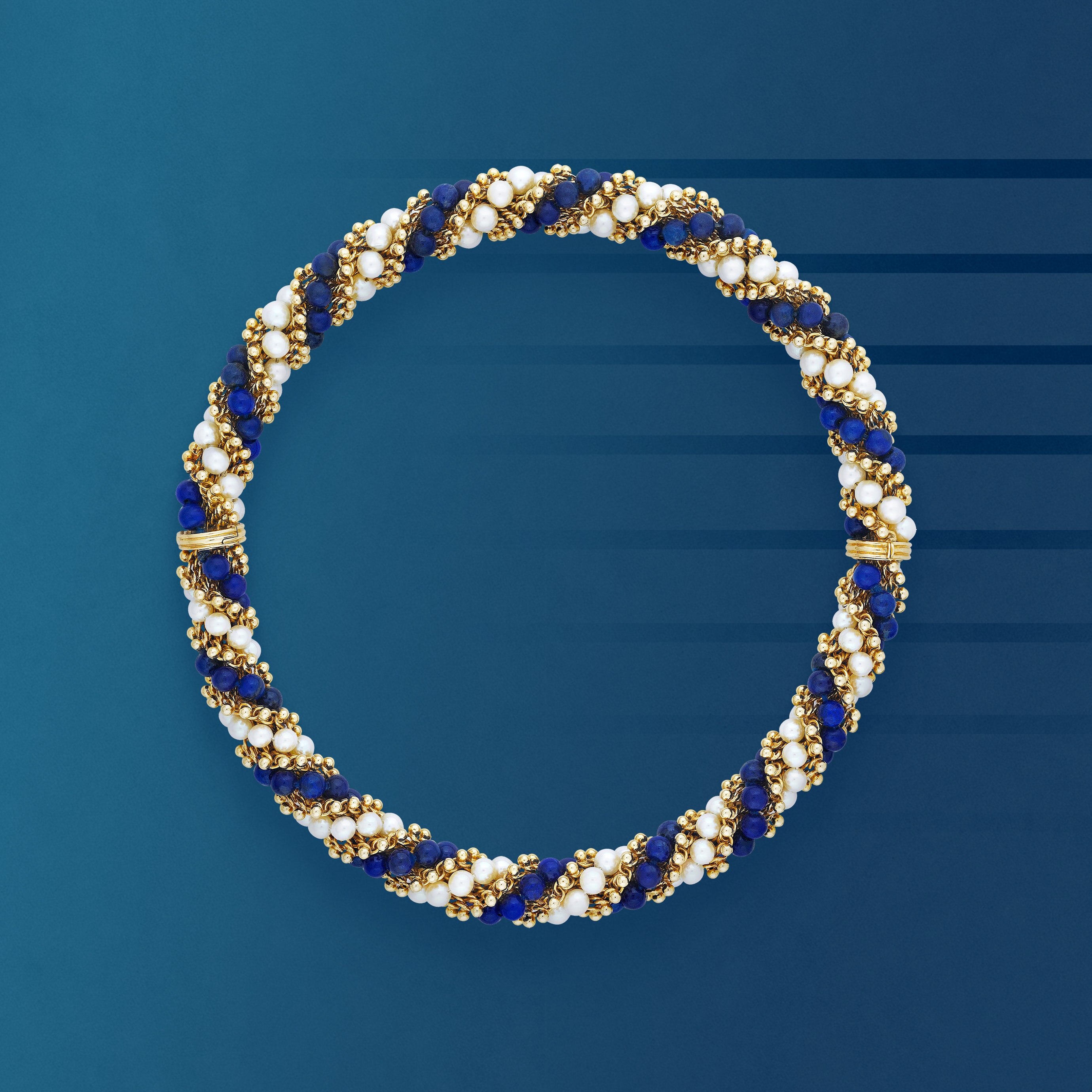 Twist necklace, 1966, transformable into two bracelets. 18K yellow gold, lapis lazuli, pearl. Van Cleef & Arpels Collection.