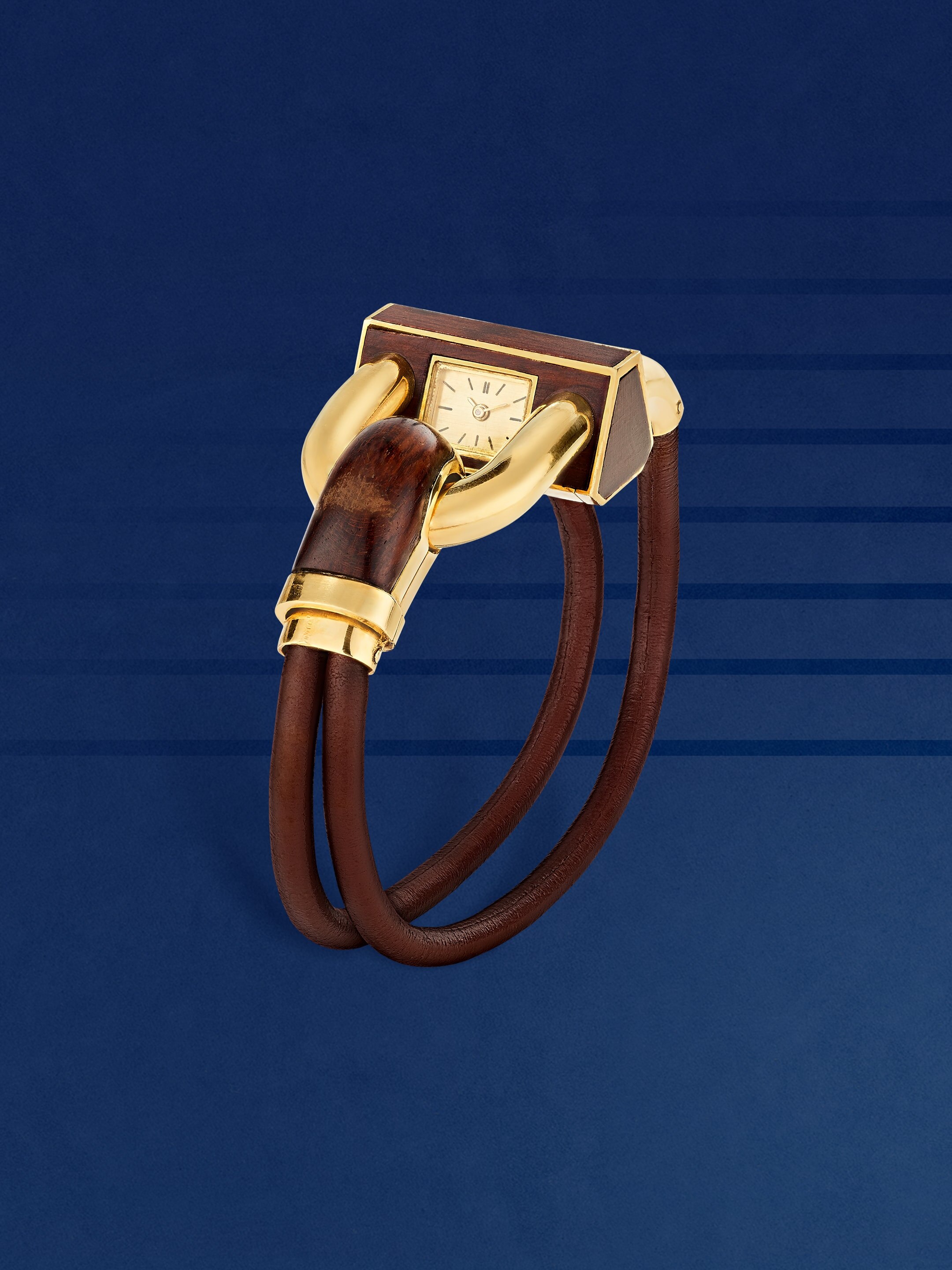 Cadenas (Padlock) wristwatch, 1972. Yellow gold, letterwood, leather. Van Cleef & Arpels Collection.