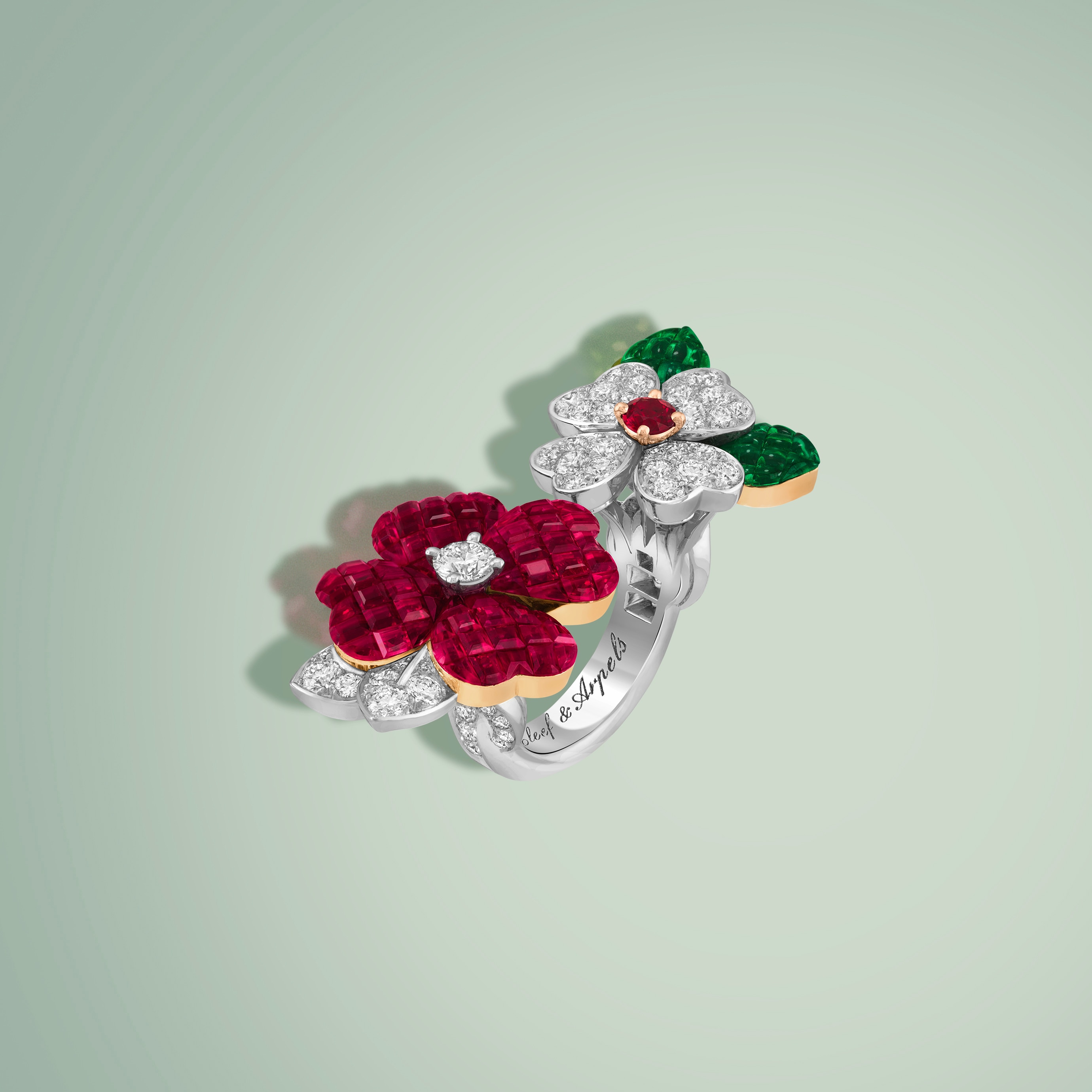 Cosmos Between the Finger ring. 18K white gold, 18K rose gold, Traditional Mystery Set™ rubies and emeralds, diamonds.. Flowers collection, Van Cleef & Arpels.
