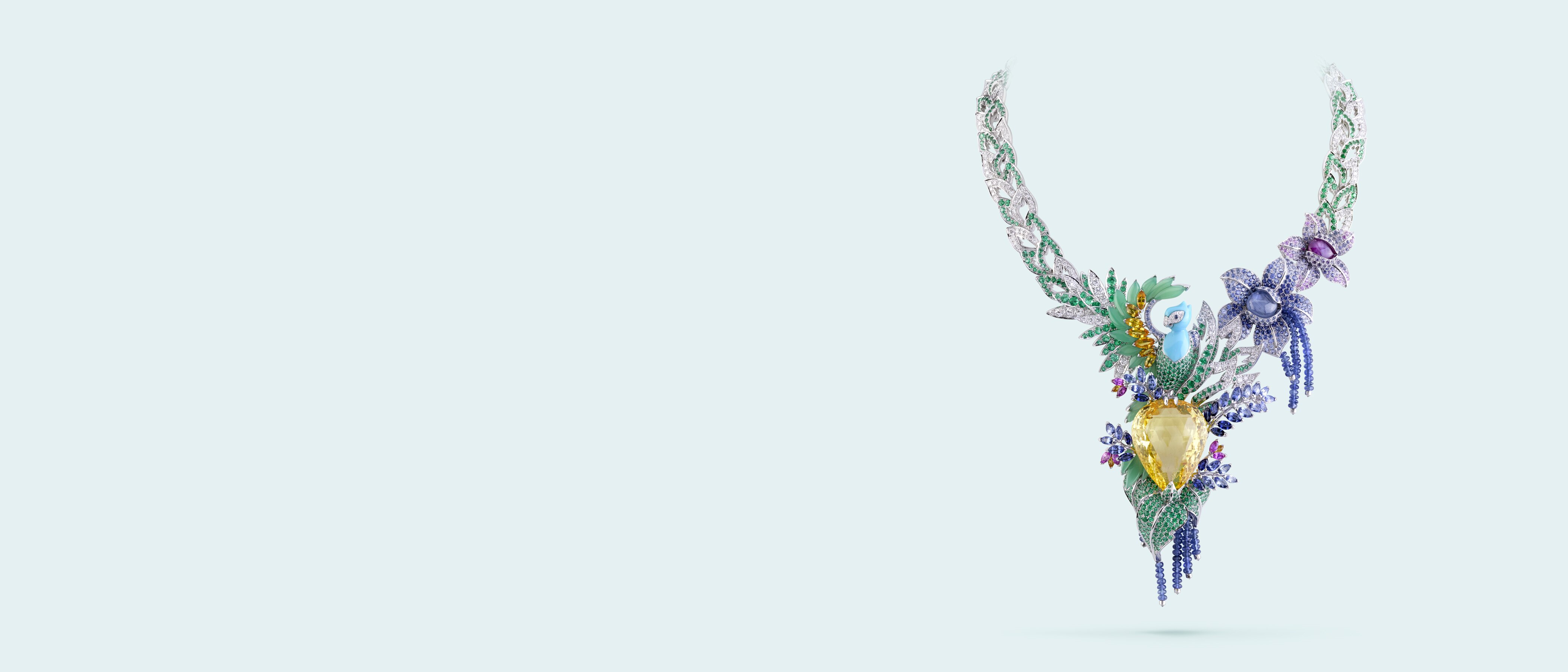 Splendeur africaine necklace. 18K white gold, sapphires, colored sapphires, two cabochon-cut star sapphires of 7.35 carats and 2.97 carats, one pink cabochon-cut star sapphire of 4.18 carats, chrysoprase, turquoise, emeralds, one yellow briolette-cut sapphire of 82.68 carats, diamonds. Private collection.