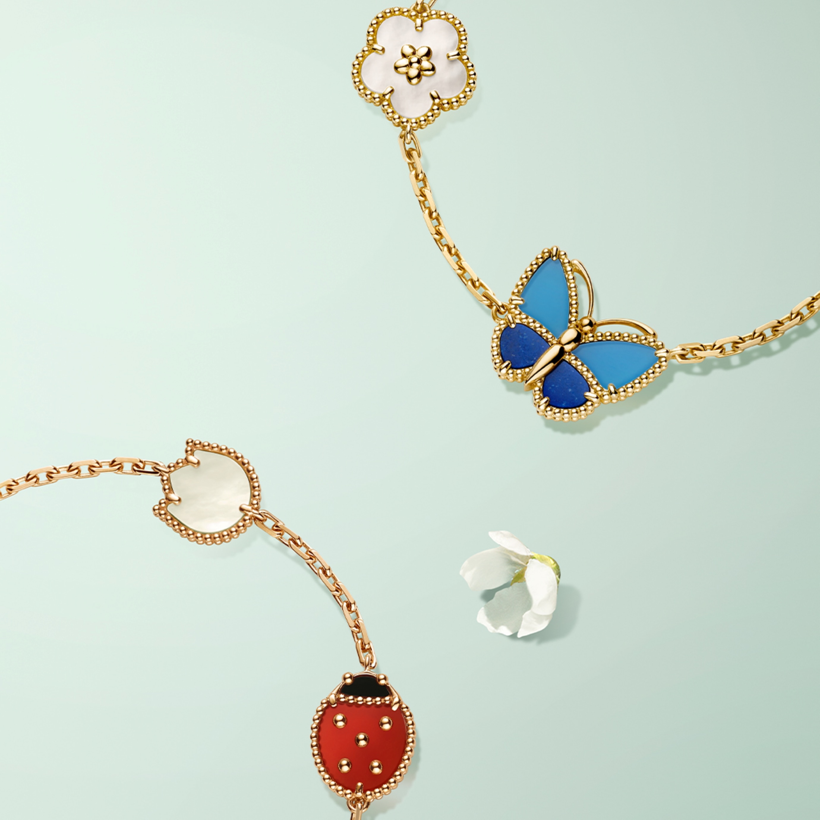 Lucky Spring bracelet, 5 motifs, 18K rose gold, white mother-of-pearl, carnelian, onyx and Lucky Spring Butterfly bracelet, 5 motifs, 18K yellow gold, lapis lazuli, blue and green agate, white mother-of-pearl. Lucky Spring® collection, Van Cleef & Arpels.