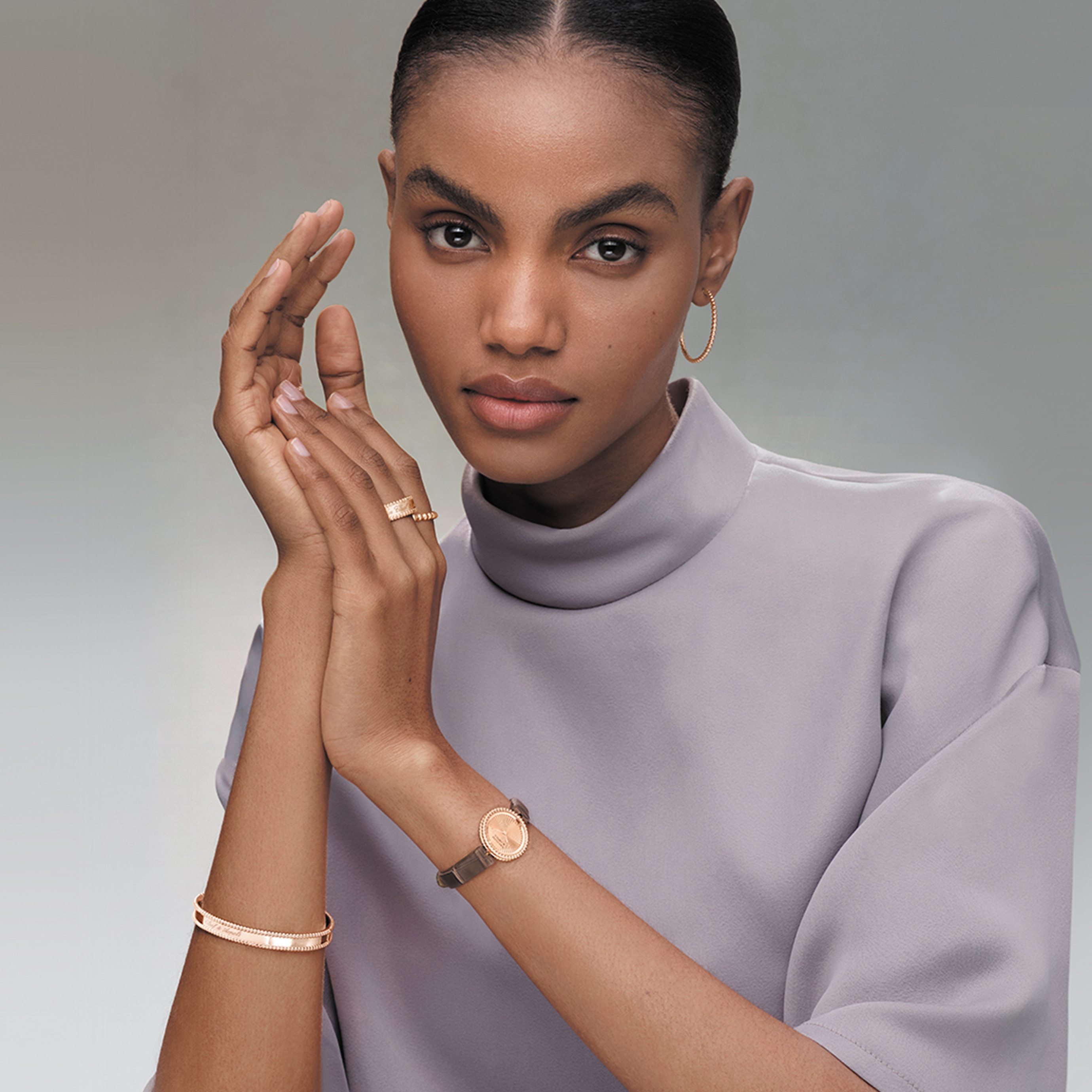 Signature bracelet and pearls of gold ring, 18K rose gold, medium model, signature ring, 18K rose gold, pearls of gold hoop earrings, small model, watch, 23 mm, 18K rose gold, guilloché 18K rose gold, Swiss quartz movement. Perlée collection, Van Cleef & Arpels.