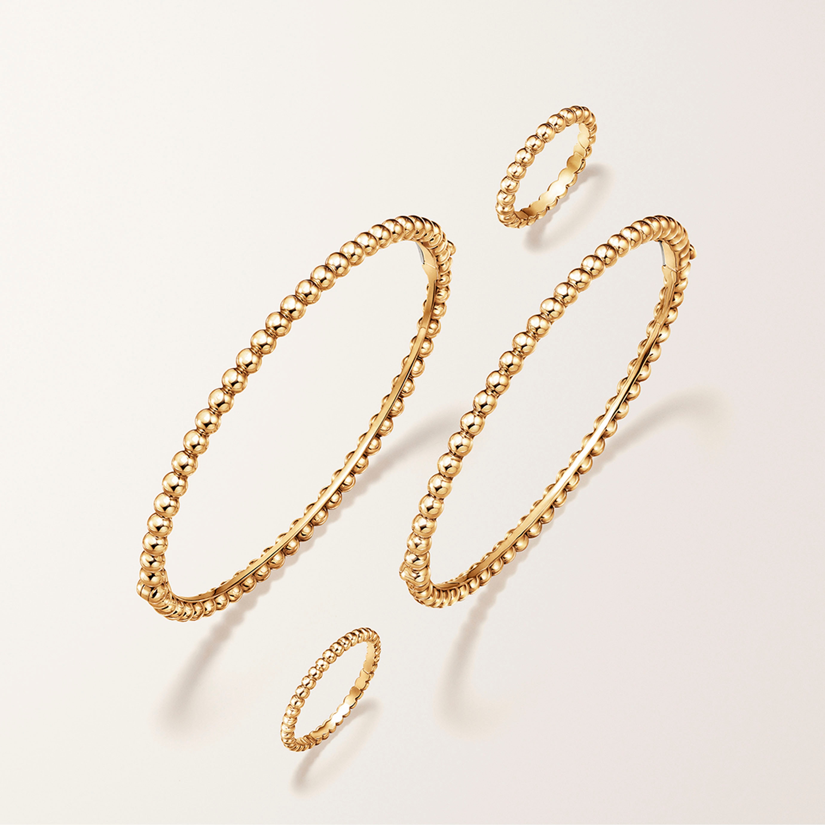 Diamonds ring, 3 rows,diamonds, couleurs ring, 3 rows, emeralds and couleurs ring, 3 rows, sapphires, 18K yellow gold. Perlée collection, Van Cleef & Arpels.