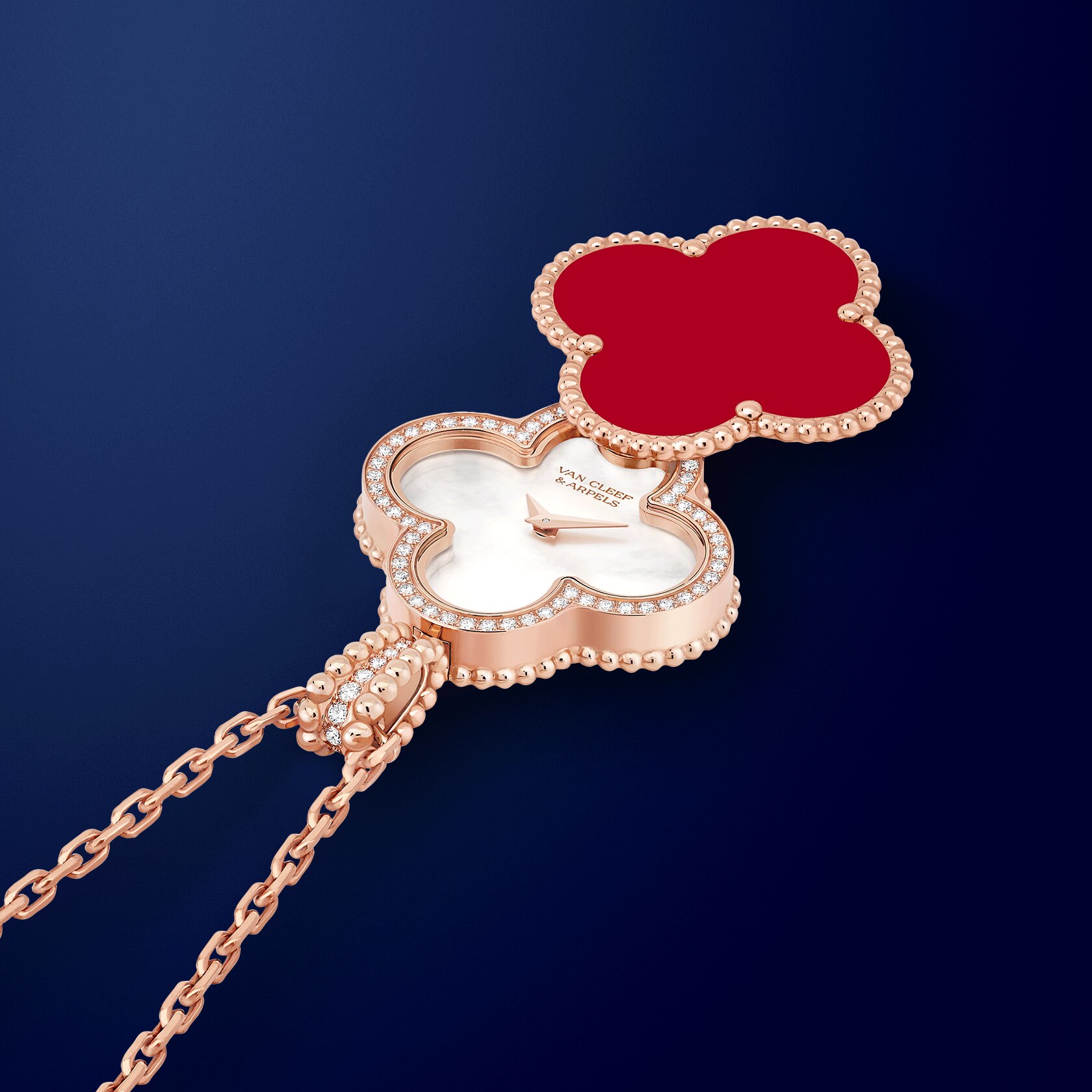 Alhambra secret pendant watch 18K rose gold, carnelian, diamonds, white mother-of-pearl, swiss quartz movement. Alhambra collection, Van Cleef & Arpels.