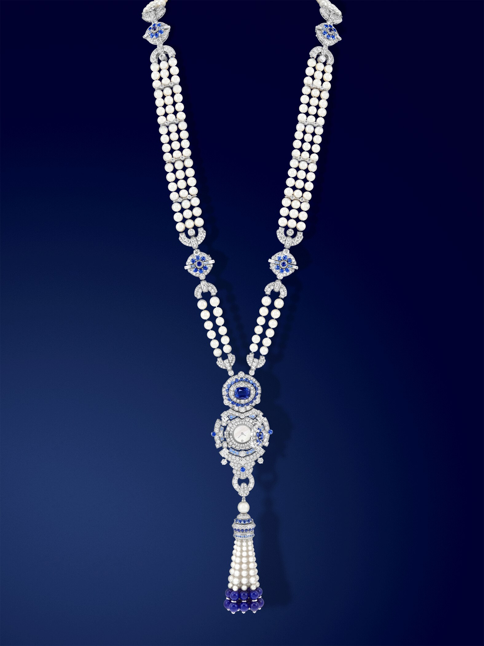 Pompon Margaret long necklace watch 18K white gold, one cushion-cut sapphire of 6,19 carats, sapphires, lapis lazuli, white cultured pearls, white mother-of-pearl, diamonds, Swiss quartz movement. Van Cleef & Arpels.