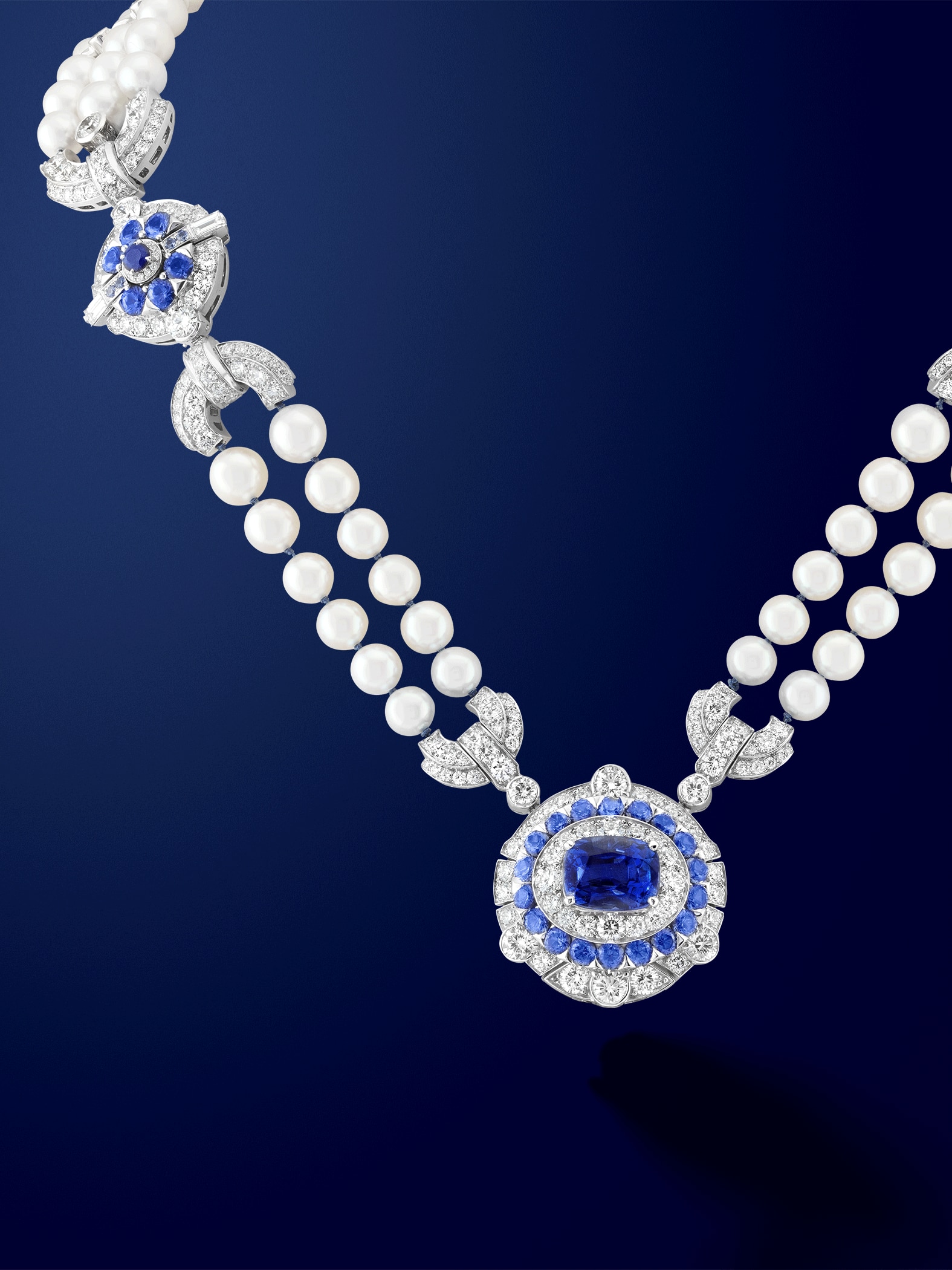 Pompon Margaret long necklace watch 18K white gold, one cushion-cut sapphire of 6,19 carats, sapphires, lapis lazuli, white cultured pearls, white mother-of-pearl, diamonds, Swiss quartz movement. Van Cleef & Arpels.