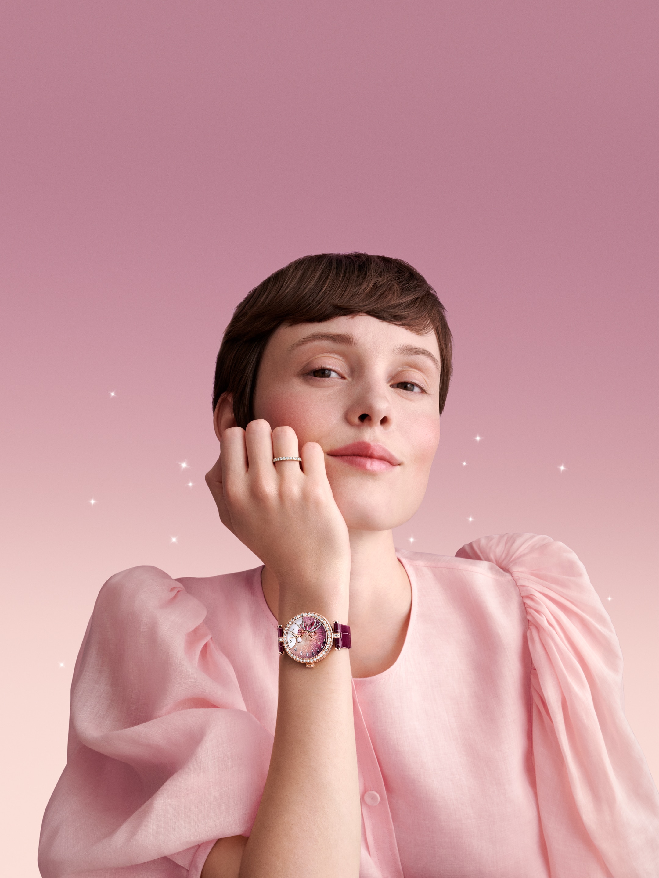 Lady Féerie Or Rose watch, 18K rose gold, rhodium plated 18K white gold, pink sapphires, diamonds, mother-of-pearl, enamel, self-winding mechanical movement, jumping hours and retrograde minutes. Watch sold with two interchangeable straps and one interchangeable pin buckle set with diamonds. Poetic Complications Collection, Van Cleef & Arpels.