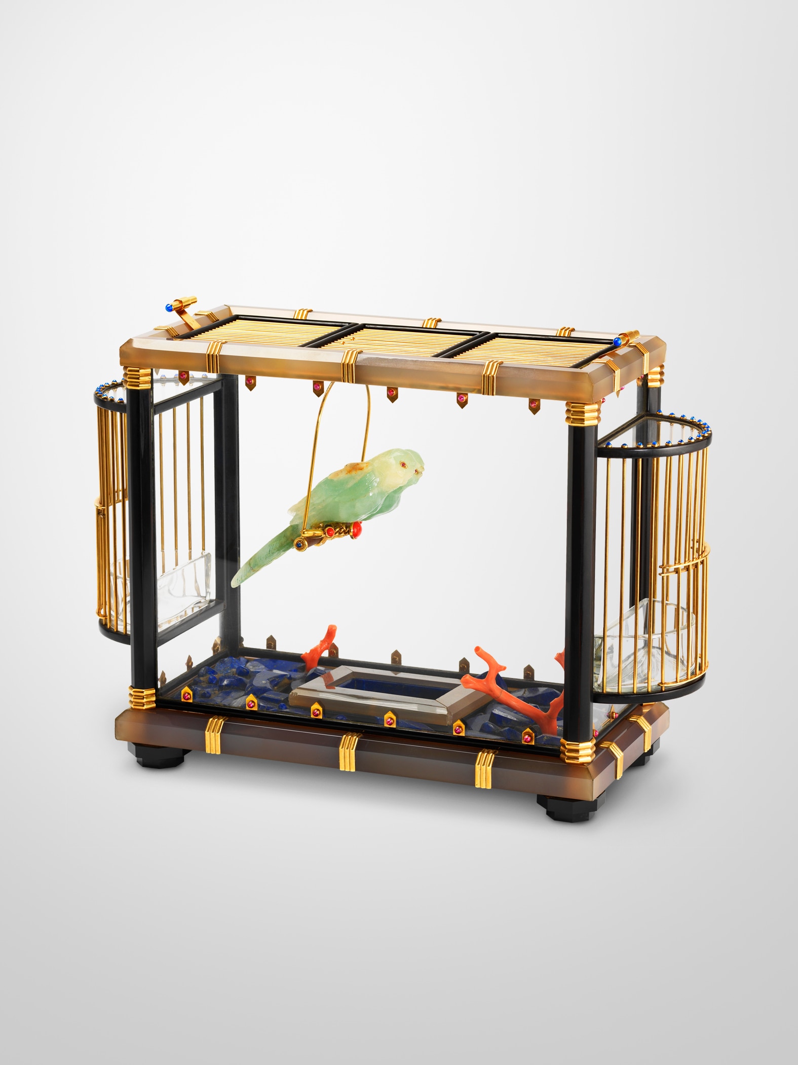 Bird cage, circa 1935, yellow gold, glass, lapis lazuli, coral, beryl, agate, enamel, wood, rubies, sapphires.   In the former collection of an unnamed Indian prince. Van Cleef & Arpels collection.