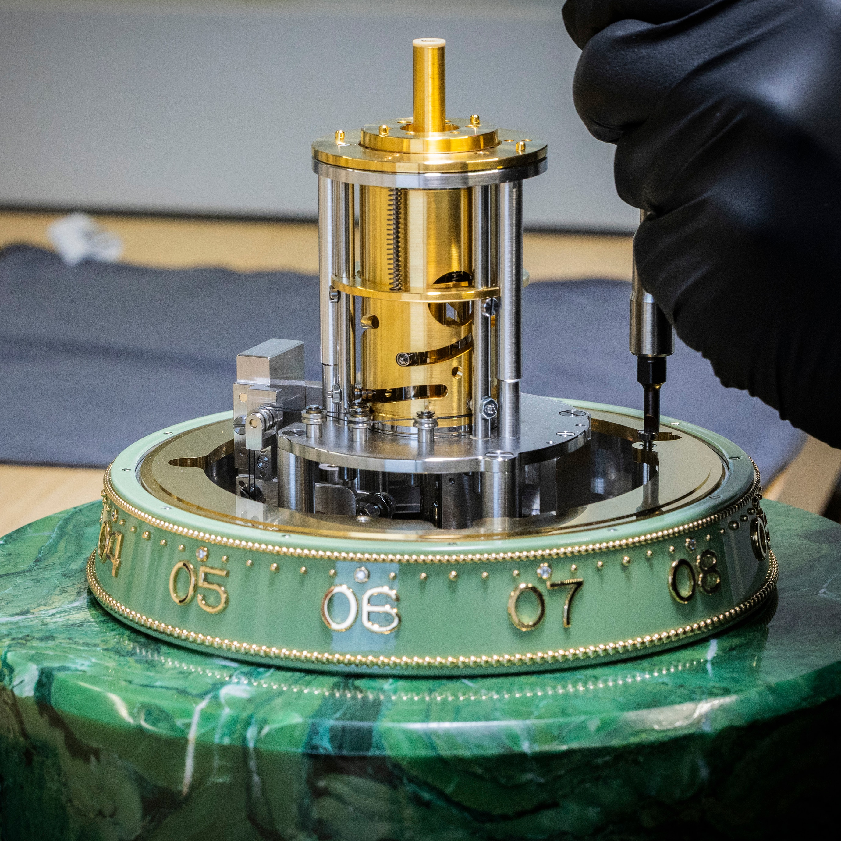 Assembling the rotating hour ring to the automaton mechanism, Van Cleef & Arpels.