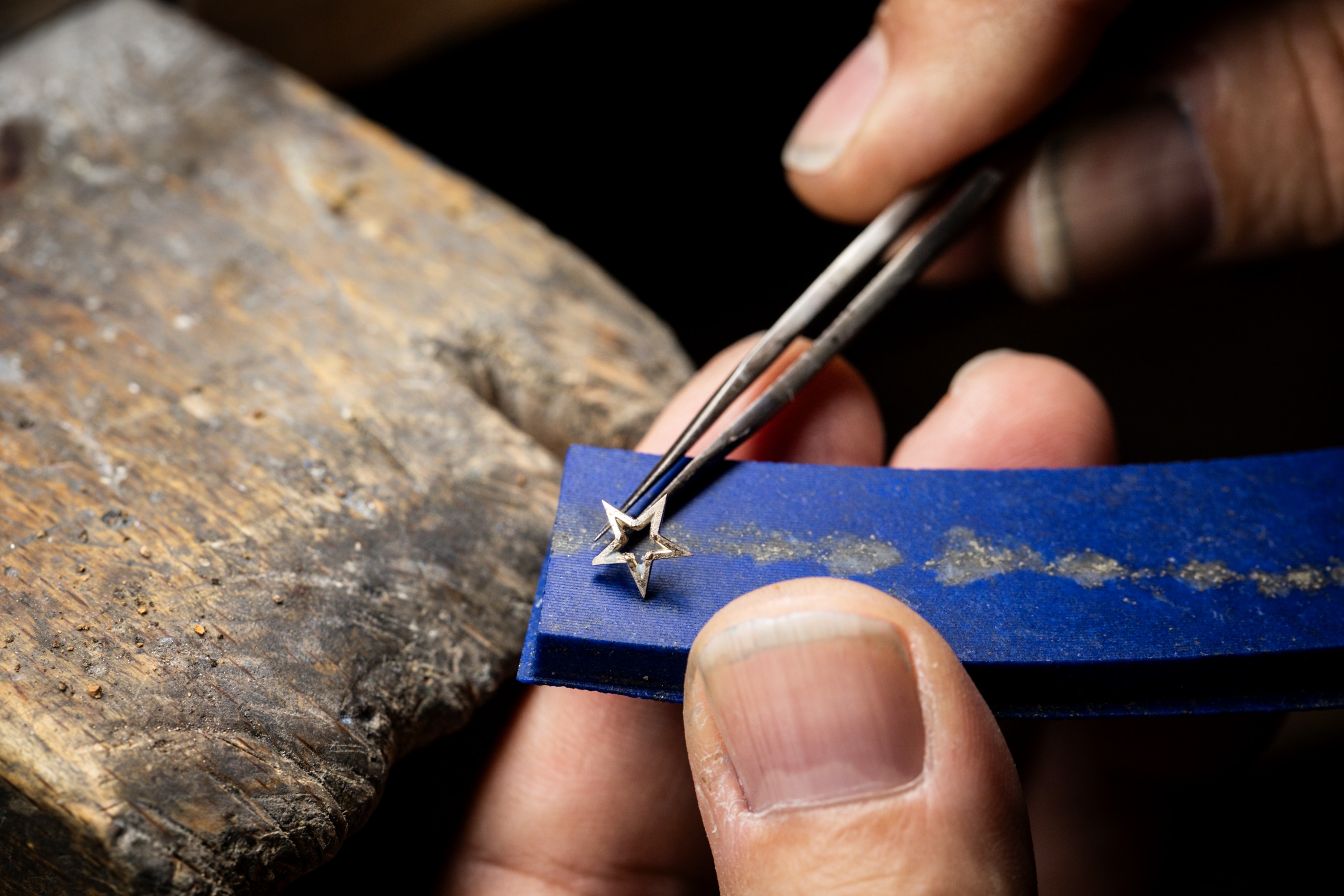 Positioning a white gold star on a lapis lazuli element, Van Cleef & Arpels.