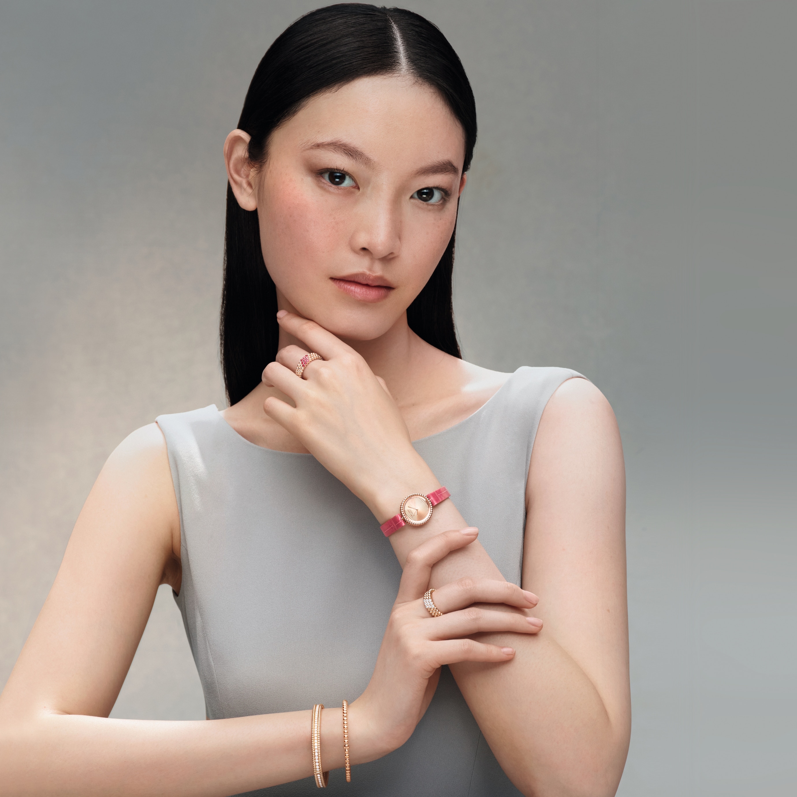 Perlée watch, 23 mm, Perlée pearls of gold bracelet, medium model, Perlée diamonds bracelet, 1 row, medium model, Perlée diamonds ring, 3 rows and Perlée couleurs ring, 3 rows, 18K rose gold, rubies, diamonds. Perlée collection, Van cleef & Arpels.