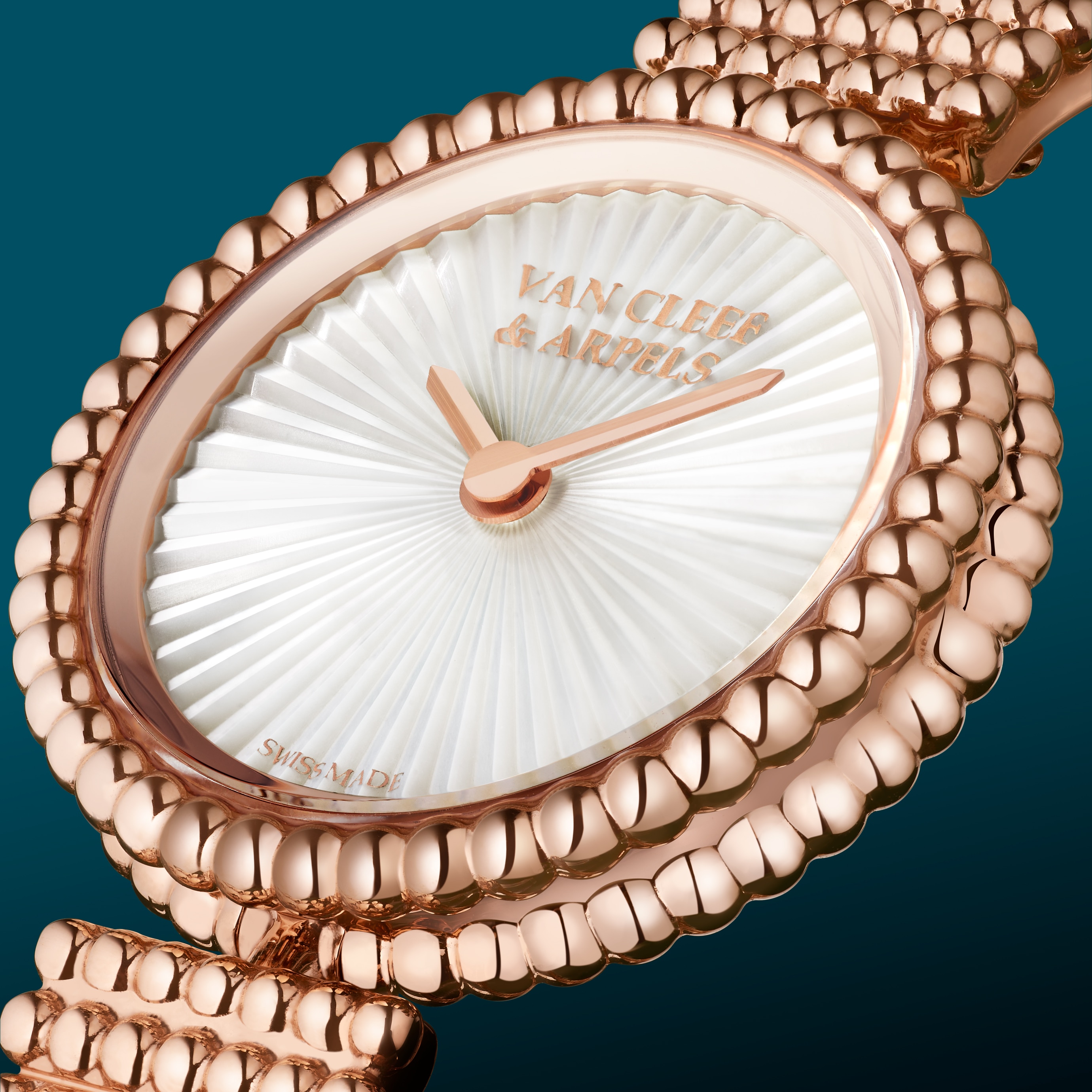 Perlée watch, 23 mm, 18K yellow gold, guilloché 18K yellow gold, Swiss quartz movement. Perlée collection, Van Cleef & Arpels.