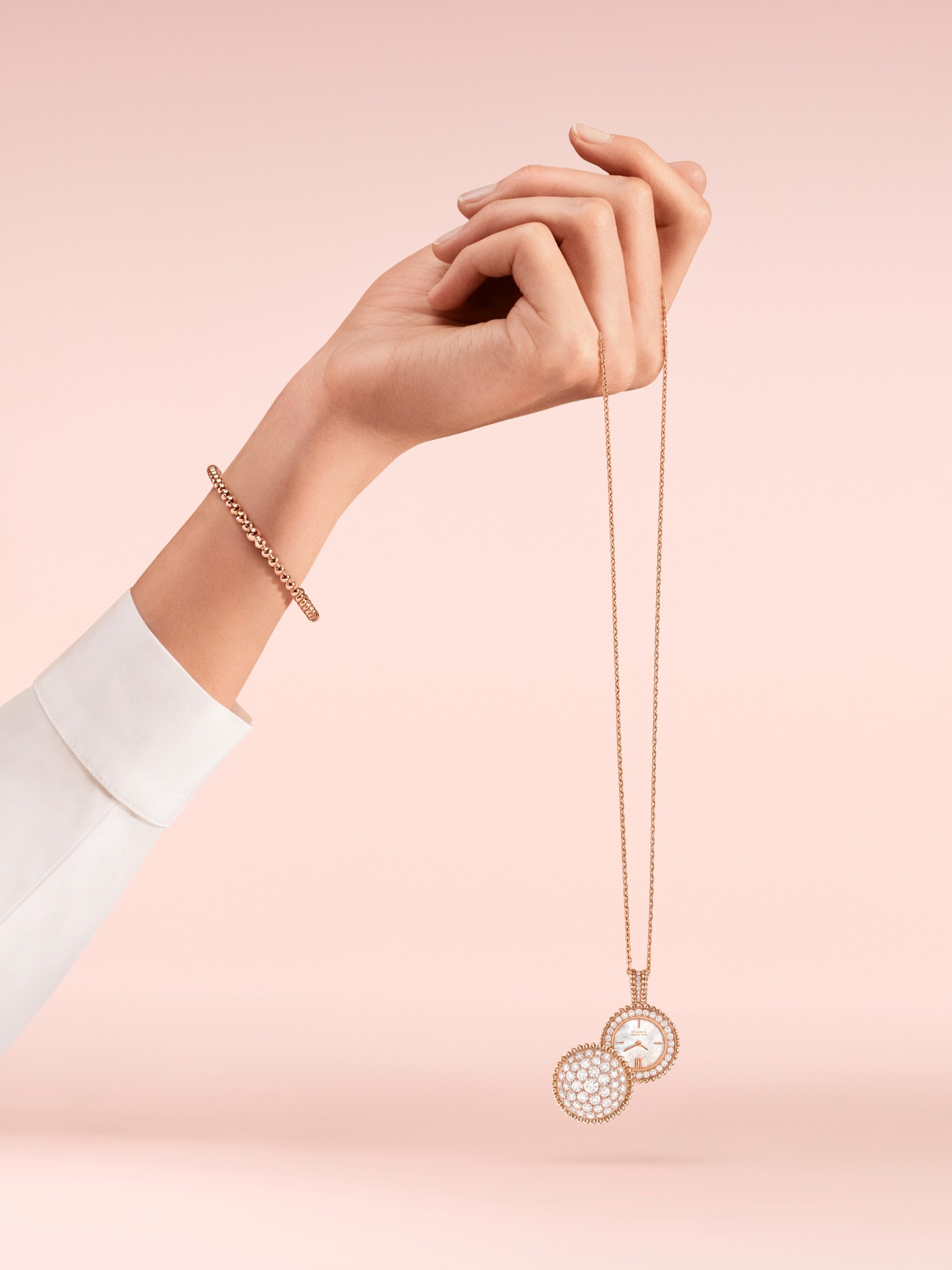 Perlée pendant watch, 18K rose gold, mother-of-pearl, diamonds, quartz movement. Perlée pearls of gold bracelet, medium model, 18K rose gold. Perlée® collection, Van Cleef & Arpels.