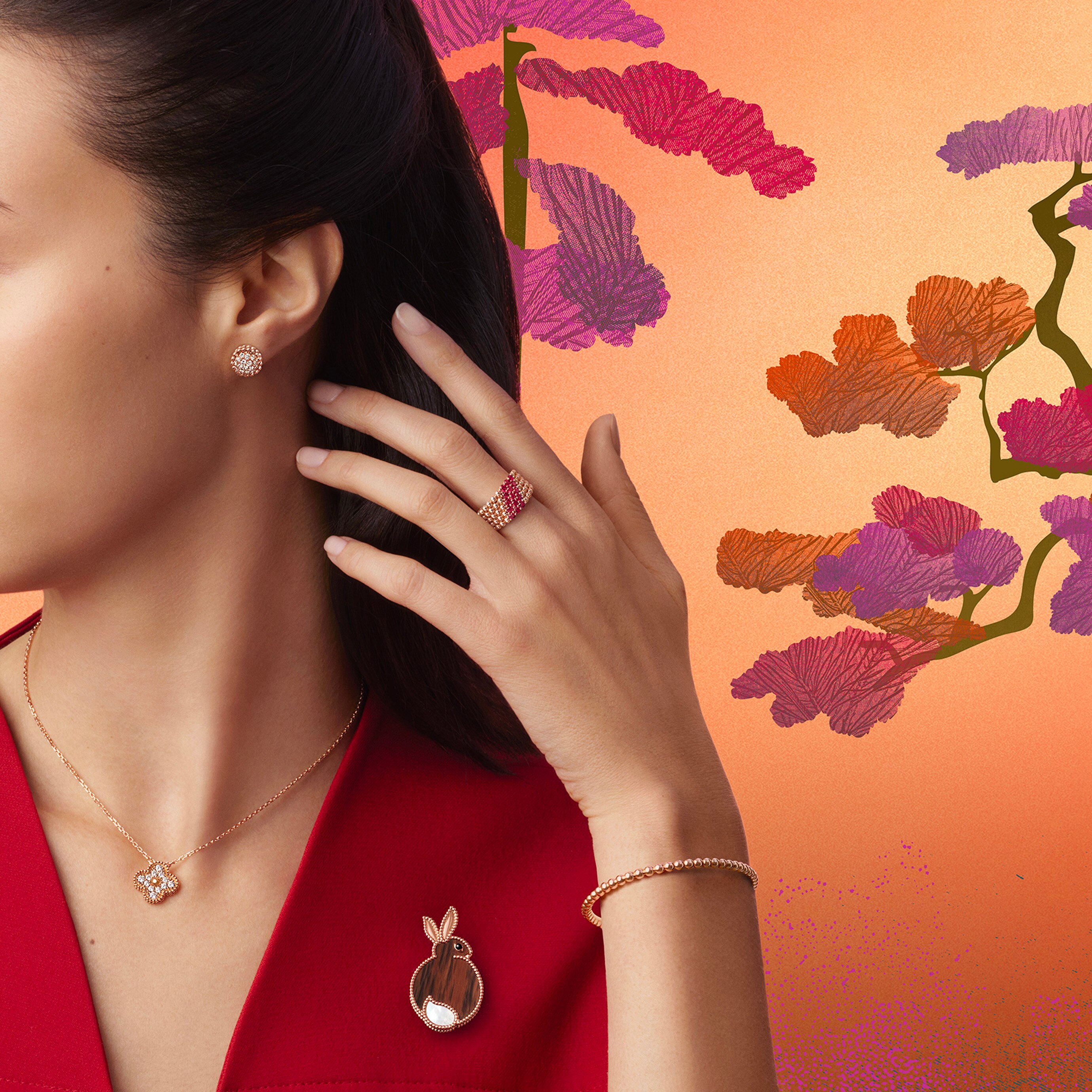 Perlée® earrings, 18K rose gold, diamonds, Perlée® ring, 5 rows, 18K rose gold, rubies, Vintage Alhambra® pendant, 18K yellow gold, diamonds, Perlée® bracelet, 18K yellow gold and Rabbit clip 8K rose gold, mahogany obsidian, white mother-of-pearl, onyx. Perlée®, Alhambra® and Lucky Animals collections, Van Cleef & Arpels.