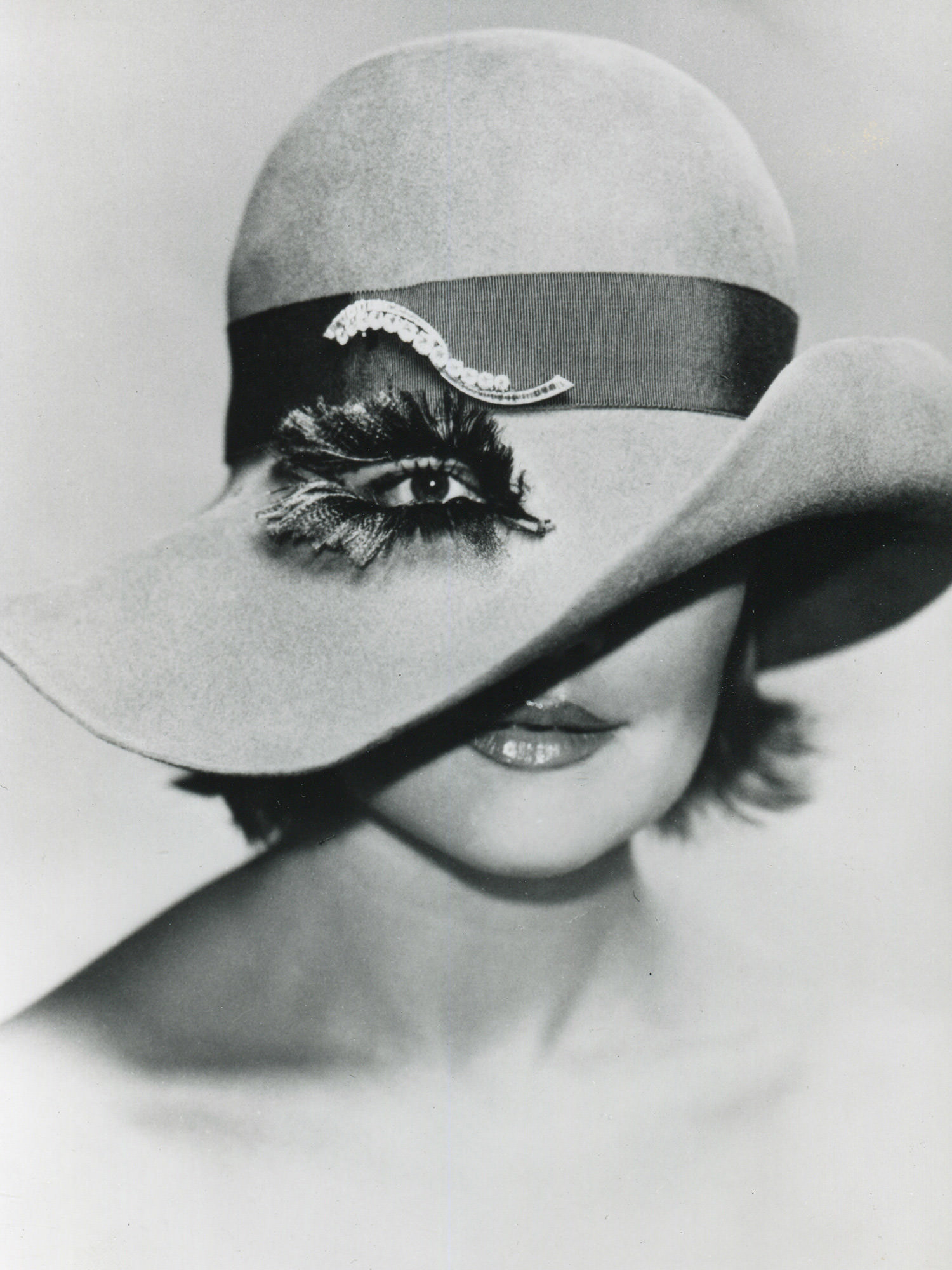 The Haricot clip by  Van Cleef & Arpels on a hat designed by the Italian couturière Elsa Schiaparelli. - Van Cleef & Arpels